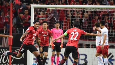Rafael Da Silva, left, celebrates with his Urawa Red Diamonds teammates after scoring the decisive goal against Shanghai SIPG. Toru Yamanaka / AFP
