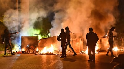 Lebanese supporters of outgoing prime minister Saad Hariri block a road with burning dumpsters in the Qasqas neighbourhood of the capital Beirut. AFP
