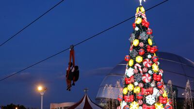 A zipline passes through a lighted Christmas tree installation at a amusement park during holiday season in Pasay, Metro Manila, Philippines. REUTERS/Dondi Tawatao