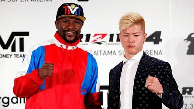 Undefeated boxer Floyd Mayweather Jr poses with his opponent Tenshin Nasukawa during a news conference in Tokyo. Reuters