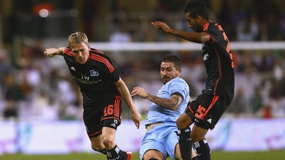 Artjons Rudnevs, left, of Hamburg challenges the ball with Manchester City’s Aleksander Kolarov on Wednesday night at the Hazza bin Zayed Stadium in Al Ain. Francois Nel / Getty Images