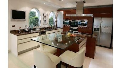 Now the kitchen looks over the dining and living areas and the terrace outside.