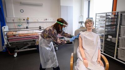Volunteers practices administering an intramuscular injection with a training model during vaccinator training to prepare volunteers to be deployed to assist in the national Covid-19 vaccination programme, at the University of Hull. AFP