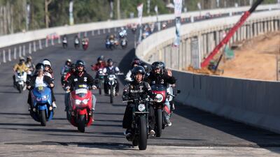 Indonesian President Joko Widodo, centre, rides a motorcycle during his visit to Indonesia's new capital city Nusantara, in East Kalimantan. EPA