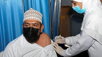 An Omani man receives a dose of the Pfizer/BioNTech Covid-19 vaccine at the Sultan Qaboos Sports Complex in Oman's capital Muscat. AFP