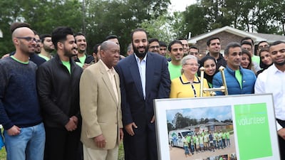 Houston Mayor Sylvester Turner, third from left, and Saudi Crown Prince Mohammed bin Salman pose with volunteers in front of a Habitat for Humanity home in Houston. The subdivision is made up of Habitat for Humanity homes that were flooded a year earlier. Volunteers from the U.S.-based subsidiary of Saudi Aramco had helped residents in the neighborhood clean up after the storm damage. Steve Gonzales / AP Photo