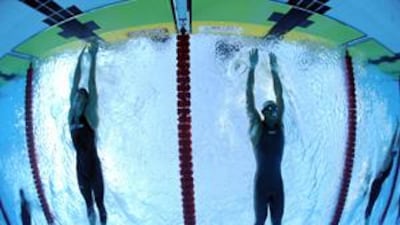 Michael Phelps of the US narrowly edged out Milorad Cavic of Serbia in the men's 100m butterfly at World Championships in Rome.