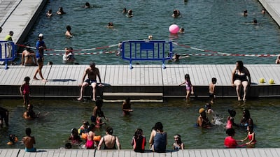 People cool off at floating pools set up on the Ourcq canal in Paris. AFP