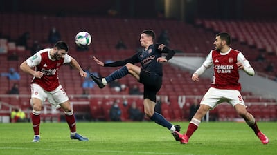 Sead Kolasinac of Arsenal defends from Phil Foden of Manchester City during the Carabao Cup Quarter Final match between Arsenal and Manchester City at Emirates Stadium on December 22, 2020 in London, England. Getty Images