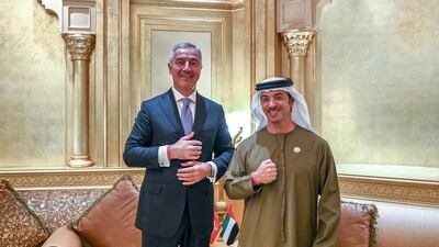 Sheikh Hazza bin Zayed, Vice Chairman of the Abu Dhabi Executive Council, and Milo Djukanovic, President of Montenegro, stand for a photograph wearing the Special Olympics World Games Abu Dhabi 2019 wrist band, at Emirates Palace. Saeed Al Neyadi / Ministry of Presidential Affairs