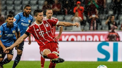 Bayern Munich forward Robert Lewandowski scores from the penalty spot during their Bundesliga win over Bayer Leverkusen in Munich. Ronaldo Wittek / EPA