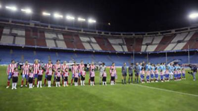Atletico and PSV line up at an empty Vicente Calderon stadium in Madrid on Wednesday.