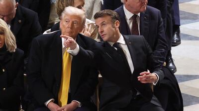 French President Emmanuel Macron (R) next to US President-elect Donald Trump (C) at the end of a ceremony to mark the re-opening of the landmark Notre-Dame cathedral, in central Paris. AFP