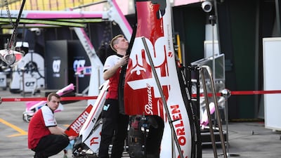 Members of the Alpha Romero team work at the Albert Park circuit ahead of the Formula One Australian Grand Prix in Melbourne. AFP