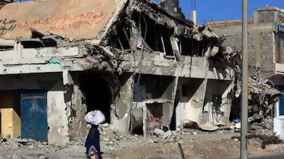 Buildings in Sirte, the home town of the late Libyan leader Muammar Qaddafi, have been turned to rubble.