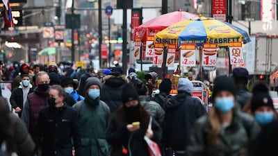 People walk through a busy shopping area in New York City. The unemployment rate in the Organisation for Economic Cooperation and Development (OECD) countries declined to 6.9 per cent in November from 7.1 per cent in October. AFP