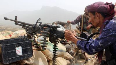 A Yemeni pro-government fighter mans a heavy machine gun.