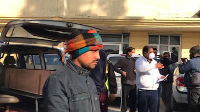 People wait to collect the bodies of their relatives. The authorities were investigating what caused the stampede at the Mata Vaishno Devi shrine. AP