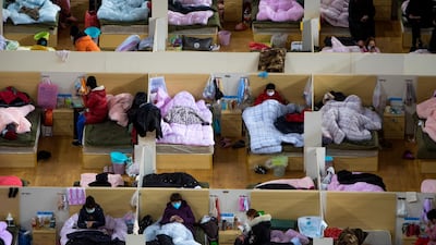 Patients infected with the coronavirus take rest at a temporary hospital converted from Wuhan Sports Center in Wuhan in central China's Hubei Province. AP