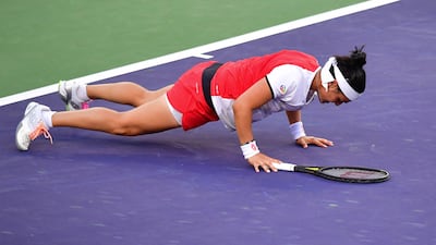 Ons Jabeur of Tunisia does a pushup on the court at Indian Wells. AFP