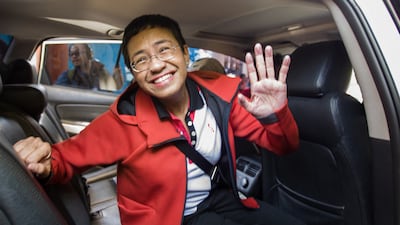The Rappler co-founder waves to photographers in Manila after posting bail, in March 2019. AFP