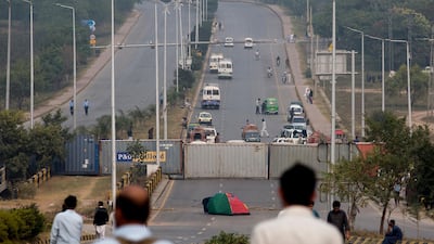 Authorities place shipping containers to stop protesters at an entrance to the capital center following a court decision in favor of a Christian woman in Islamabad, Pakistan. Christian woman Asia Bibi acquitted in Pakistan after eight years on death row for blasphemy plans to leave the country, her family said Thursday as radical Islamists mounted rallies for a second day against the verdict, blocking roads and burning tires in protest. AP Photo
