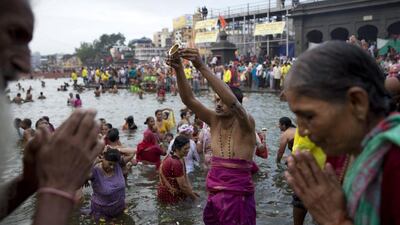 Thousands of devout Hindus splash into the west Indian river for the first official day Wednesday of bathing at one of the country’s largest festivals.