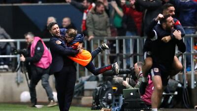 Bristol City manager Lee Johnson celebrates with a ball boy. David Klein / Reuters