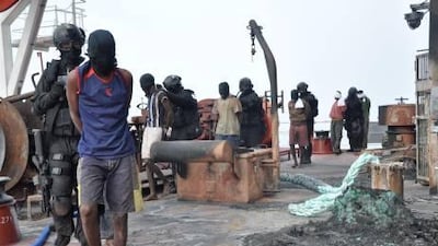 The UAE’s elite counter-terrorism troops lead the captured pirates off the MV Arillah-I after the daring raid on Saturday.