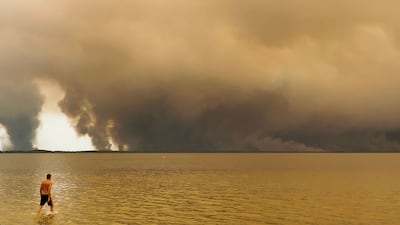 Clouds of smoke caused by wildfires drift past a beach in Lacanau, south-western France. AFP