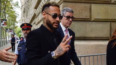 Neymar gestures as he leaves after attending the opening audience at the courthouse in Barcelona. AFP