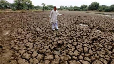 Cane and rice farmer Satyavan Narwal at a dried-up pond bed in Kathura village, Haryana, India.