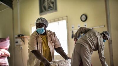 Virginia Ramuhuhu hauls bags of baobab fruit seeds at the Eco Products lab headquarters in Louis Trichardt, in the Limpopo Province, on August 27, 2018. AFP