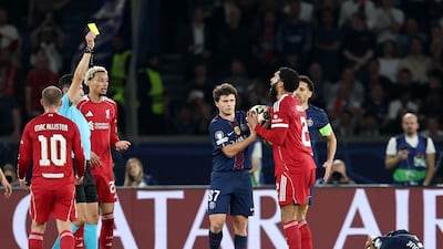 Liverpool's Joe Gomez is shown a yellow card by referee Jose Maria Sanchez Martinez. Reuters