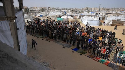 Friday prayers next to tent housing displaced Palestinians in Khan Younis, southern Gaza. AFP