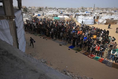 Friday prayers next to tent housing displaced Palestinians in Khan Younis, southern Gaza. AFP