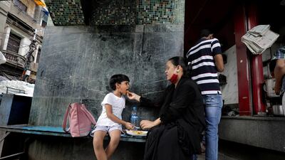 An Indian family eats lunch at a street food stall in Kolkata, Eastern India, October 9. Piyal Adhikary / EPA