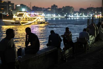 Egyptians sitting on the banks of the Nile in Cairo. Bloomberg