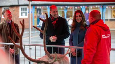 Prince William, and Catherine, Duchess of Cambridge chat with a reindeer handler during a visit to the Holy Trinity Church of England First School in Berwick-Upon-Tweed, north-east England. AFP