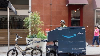 A delivery worker loads a bicycle trailer with Amazon boxes in New York. EPA
