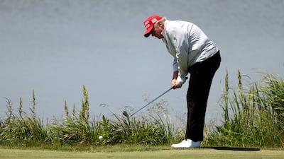 Mr Trump chips to the 11th green. AFP