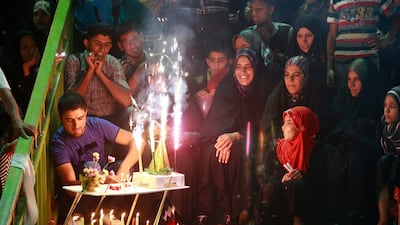 In this photo taken Thursday, July 5, 2012, Shiite pilgrims light candles and fireworks inside the courtyard of the Imam Hussein shrine during the annual festival of Shabaniyah, which marks the anniversary of the birth of the ninth-century Shiite leader known as the Hidden Imam, in Karbala, 50 miles (80 kilometers) south of Baghdad, Iraq. Religious Shiites refer to Mohammed al-Mahdi as the "Hidden Imam," believing he was spared death and will return to Earth to bring peace and justice. (AP Photo/Hadi Mizban)