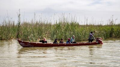 Tourists sit in a canoe as they are shown around the marshes of the southern Iraqi district of Chibayish in Dhi Qar province, about 120 kilometres northwest of the southern city of Basra. AFP