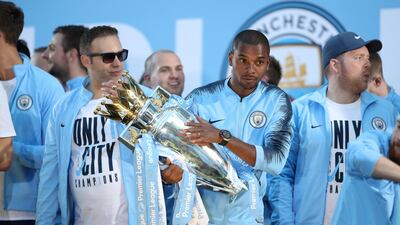 Fernandinho of Manchester City holds the trophy during the Manchester City trophy parade. Lynne Cameron / Getty Images