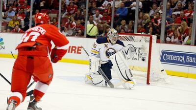 Henrik Zetterberg (left) beats goalie Ryan Miller to net the game-tying goal for Detroit against Buffalo on Thursday night. Gregory Shamus / Getty Images / AFP
