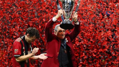 Atlanta United owner Arthur Blank lifts the MLS Cup. Reuters