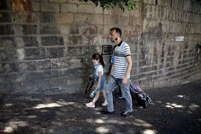 A man with his children at the end of their school day in Beirut, in 2021. AP