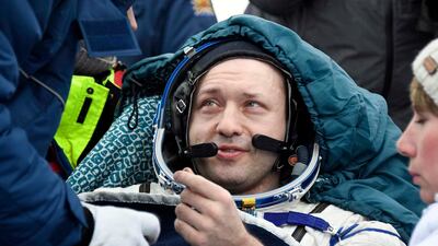 Russian cosmonaut Alexander Misurkin rests in a chair after landing in a remote area south-east of the Kazakh town of Zhezkazgan, Kazakhstan. Alexander Nemenov / Pool Photo via AP