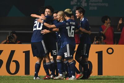 Japan's Ayase Ueda, No 15, celebrates with his teammates after scoring a goal against the UAE. AFP