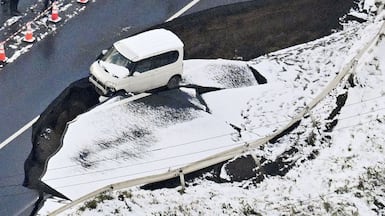 This aerial photo shows a damaged road in Tohoku town in northern Japan. AP